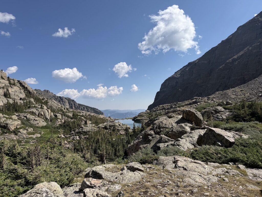 Photo of lake in the distant valley with blue sky