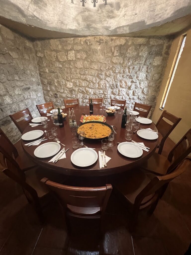 Round table set for many people, paella in the middle at San Bol, one of the best places to stay on Camino Frances