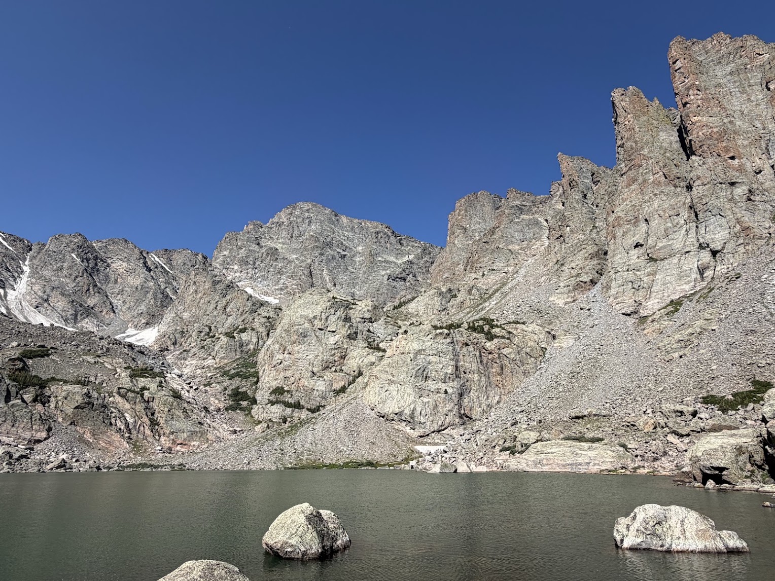 Lake in foreground and spikey dramatic peaks behind
